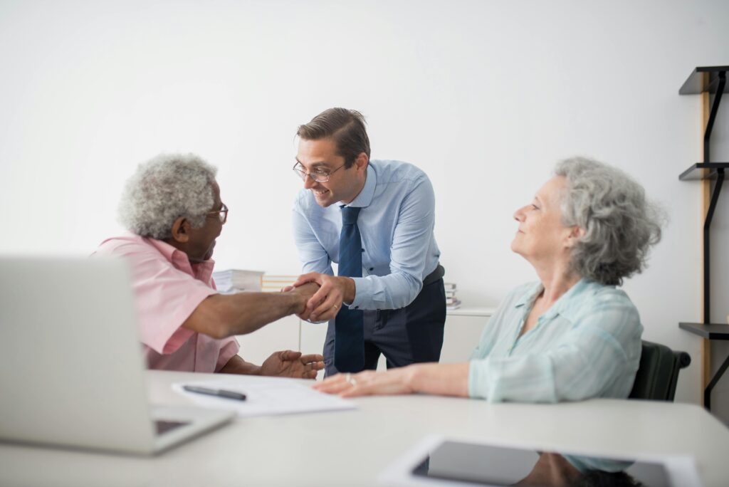pexels-photo-8441863-8441863 Business professional meeting with senior clients in an office setting, showcasing diversity and cooperation.